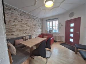 a room with a table and a brick wall at Apartment Peacock - Steinbock Lodges in Zell am See