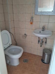a bathroom with a toilet and a sink at Aylida House in Paralía Avlídhos +35 photos