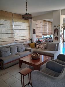 a living room with couches and a coffee table at Aylida House in Paralía Avlídhos