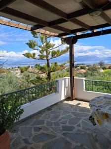 a view from the balcony of a house with a tree at Aylida House in Paralía Avlídhos