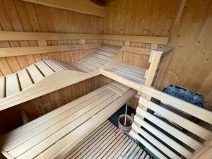 a large wooden sauna with two beds in it at Gasthuys Rooy in Stramproy