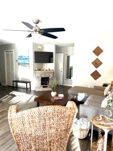 a living room with a couch and a table at Boutique Coastal Retreat in Edisto Island