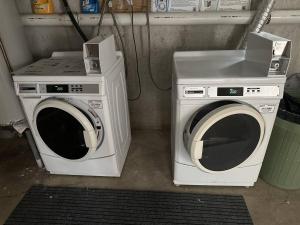 two washing machines sitting next to each other in a room at Stunning Bay Views | Beach Access - Deck - Parking in Provincetown