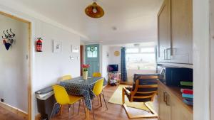 a kitchen and dining room with a table and chairs at E08 Boness E8, Riviere Towans in Hayle