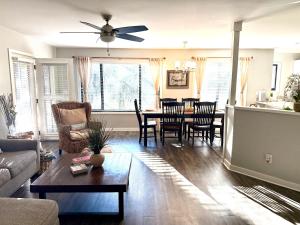 a living room with a couch and a table at Boutique Coastal Retreat in Edisto Island