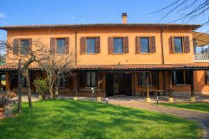 a large orange house with a lawn in front of it at Corina's Place Bologna Home in Bologna