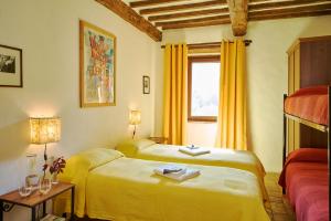 a hotel room with two beds and a window at Agri Ostello Valle Libera in Chianaiola