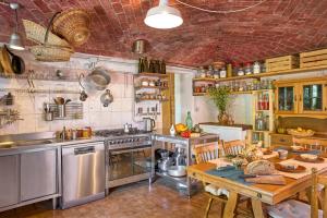 a kitchen with a table and a stove and a table sidx sidx sidx at Agri Ostello Valle Libera in Chianaiola +39 photos