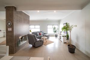 a living room with a couch and a fireplace at Bella Luna Bed and Breakfast in Walvis Bay
