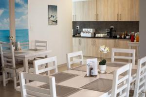 a kitchen and dining room with a table and chairs at Bella Luna Bed and Breakfast in Walvis Bay