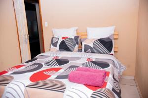 a bedroom with two beds with pillows at Falcon Lodge ET in Bela-Bela +10 photos