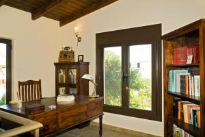 a room with a desk and a window with books at Villa Nefeli in Stavros