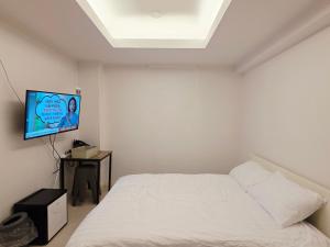 a bedroom with a bed and a flat screen tv at GaGa Hotel dongdaemun in Seoul +16 photos