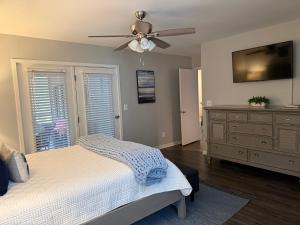 a bedroom with a bed and a ceiling fan at Boutique Coastal Retreat in Edisto Island +21 photos