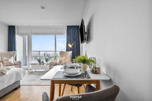 a living room with a table and a couch at Ferienwohnung Seeblick 203 Büsum in Büsum