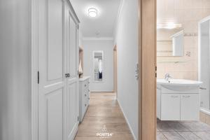 a white bathroom with a sink and a mirror at Ferienwohnung Hummer Büsum in Büsum