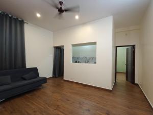 a living room with a couch and a mirror at TADY Homes in Tiruvannāmalai
