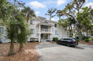 a house with a car parked in front of it at Boutique Coastal Retreat in Edisto Island