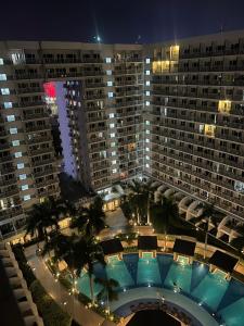 an aerial view of a large building with a pool at Shell Residences Tower A B in Manila