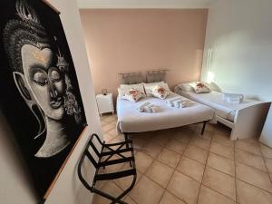 a room with two beds and a painting on the wall at Salento Casa Vacanza Il Focolare in Torchiarolo