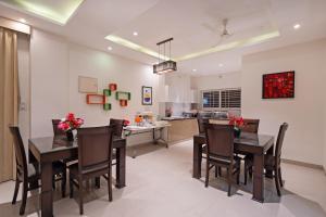 a kitchen and dining room with a table and chairs at Treebo Brixton Luxe in Bangalore