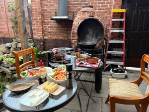 a table with food and a grill on a patio at BFamily-Jacks Court in Stalybridge