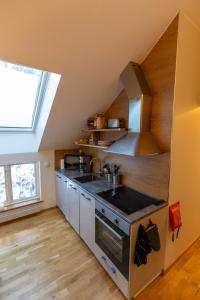 a kitchen with a sink and a stove at Annexet Hjälmareds mill in Alingsås
