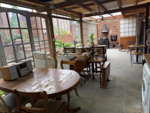 a large room with tables and chairs and windows at BFamily-Jacks Court in Stalybridge