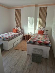 a bedroom with two beds and a window at FeWo LoBec 2 in Calau