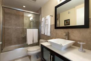 a bathroom with a sink and a toilet and a mirror at Westover Arms Hotel in Miami Beach +66 photos