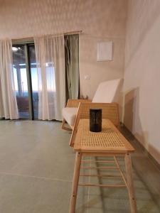 a room with a table and a chair and window at שיר ערש in Giv'at Yo'av