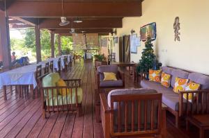 a dining room with tables and chairs and a christmas tree at Zara Village in Nosy Be
