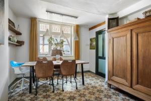 a dining room with a table and chairs at boerderij, voorhuis in Schimmert