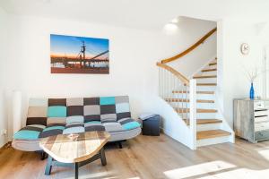 a living room with a couch and a table at Ferienwohnung Ebbe in Tannenhausen +17 photos