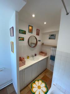 a bathroom with a sink and a mirror at Maison au coeur de Guéthary in Guéthary +24 photos