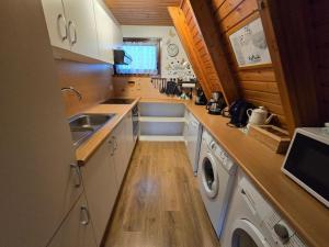 a small kitchen with a sink and a washing machine at Haus Stern Carolinensiel in Carolinensiel