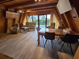 a living room with a dining table and chairs at Haus Stern Carolinensiel in Carolinensiel