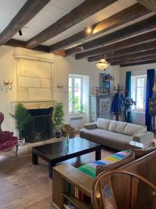 a living room with a couch and a fireplace at Maison au coeur de Guéthary in Guéthary