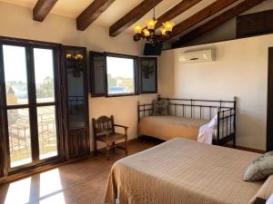 a bedroom with two beds and a balcony at La iaia Merce in L'Aldea