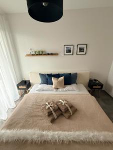 a bedroom with a large bed with two pillows on it at Elcami Living in Fritzens