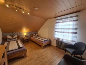a room with two beds and a window at Fewo Perle Medebach in Medebach
