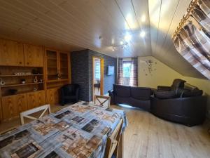 a living room with a table and a couch at Fewo Perle Medebach in Medebach