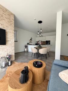 a living room with a blue couch and a table at Elcami Living in Fritzens