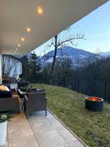 a patio with a couch and a table with a view at Elcami Living in Fritzens