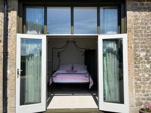 a room with a bed inside of a house at The Stables in Corsley