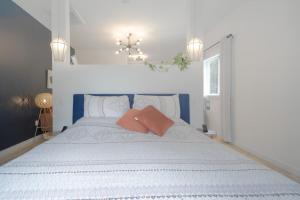 a bedroom with a large white bed with two pillows at Flora Studio on the Lake in Saint Martins