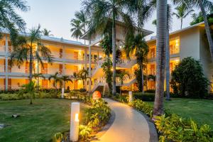 an exterior view of a hotel with palm trees at Vista Sol Punta Cana Beach Resort & Spa - All Inclusive in Punta Cana +113 photos