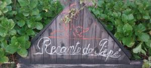 a wooden gate with graffiti on it with plants at recanto de pepe 1 in Santa Vitória do Palmar