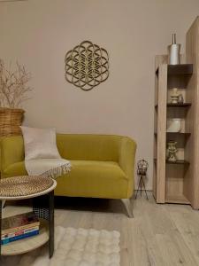a living room with a green couch and a table at Maya Apartment in Cluj-Napoca