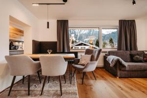 a kitchen and dining room with a table and chairs at Schöne Aussicht in Riezlern